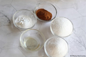 All the ingredients for these Pumpkin Spice Bath Salts sit in individual bowls.