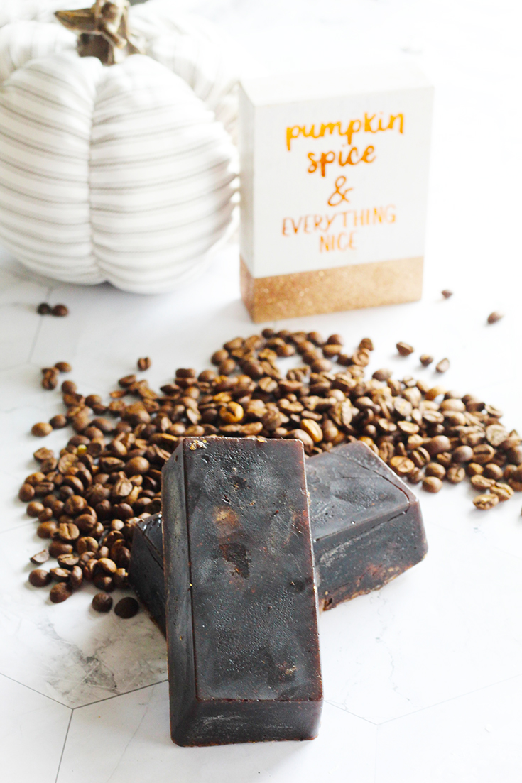 Two bars of this Pumpkin Spice Latte Soap sit in a pile of coffee beans.