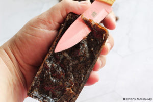 Step 6 is to remove the chilled soap bars from the mold and cut off any uneven parts.