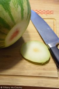 Step one is to stabilize your watermelon by slicing a bit off the bottom.