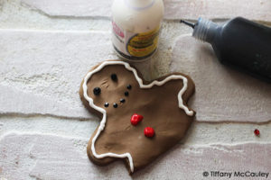 Step nine is to decorate your gingerbread man and insert into the mug topper.