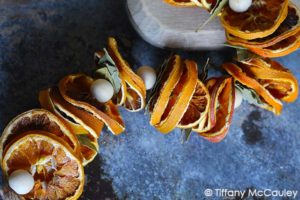Thread all the leaves and orange slices, then tie off the end.