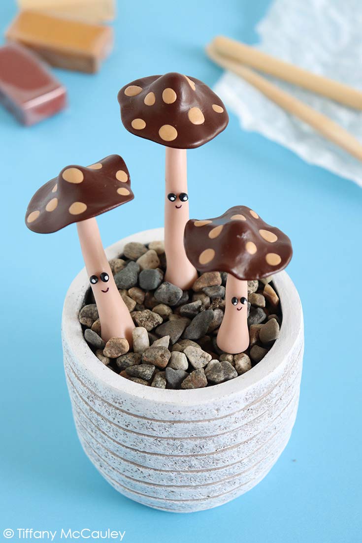 Three Polymer Clay Mushrooms in a small, white pot.