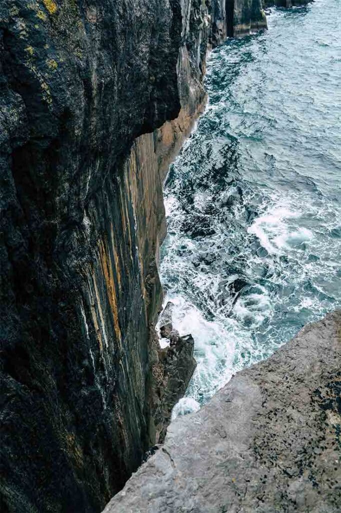 Steep cliffs looking down into the ocean in Ireland, Northern Europe.