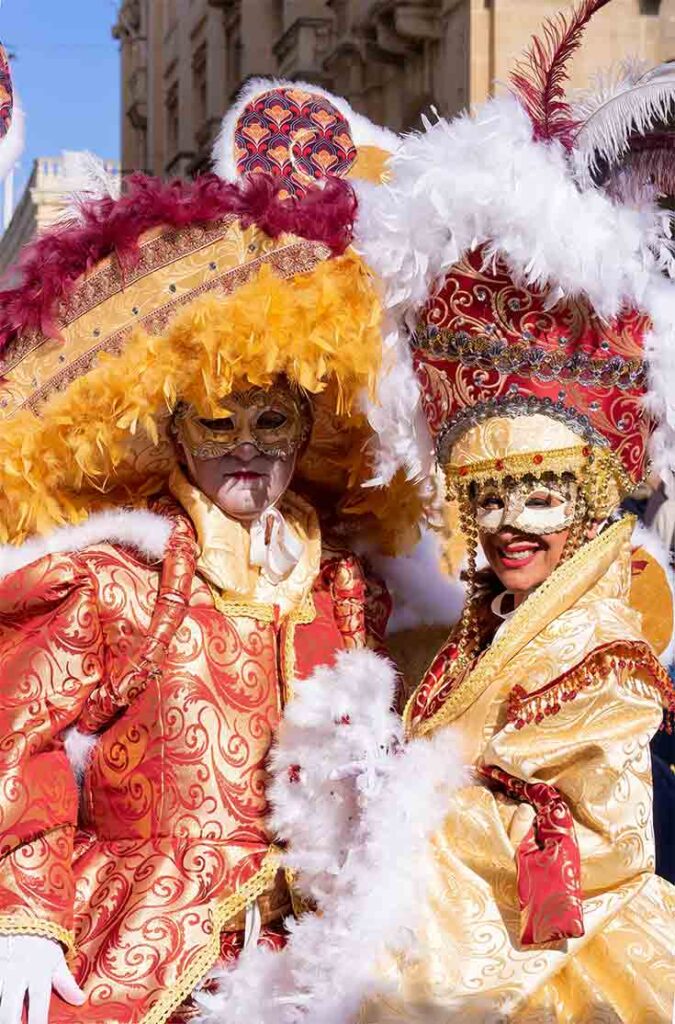 And man and woman in carnival costumes.
