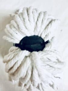 The underside of a string mop head.