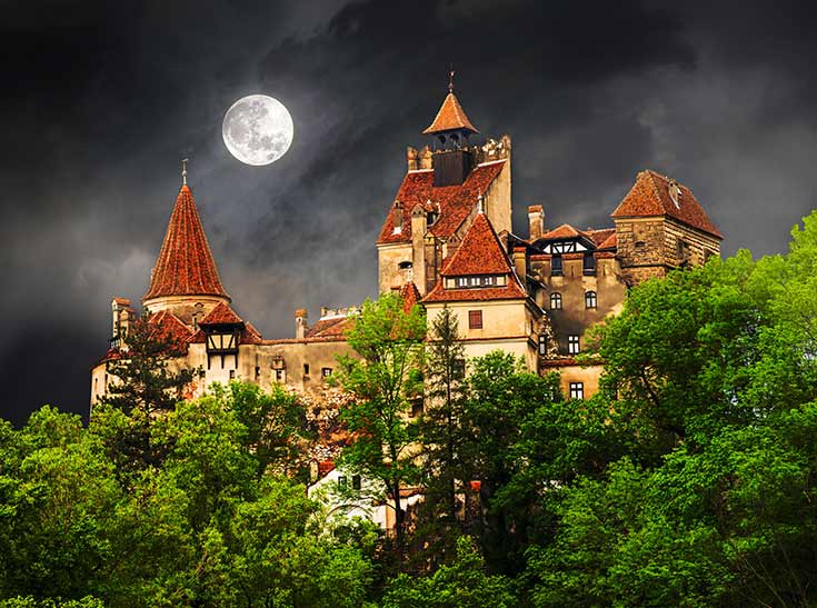 Dracula's castle in Transylvania, under a full moon.